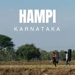 The journey is part of the adventure. Here, two of our crew walk through the paddy fields of Hampi, Karnataka, carrying crash pads on their way to the boulders.