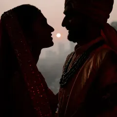 A stunning silhouette portrait of the bride and groom against the setting sun. These artistic shots are dramatic and incredibly romantic.