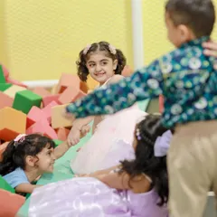 Building, jumping, and tumbling in our soft foam block pit. This area is perfect for creative construction and energetic play.