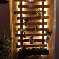To create a dramatic effect at night, I designed this wooden pallet-style wall planter with hidden LED backlighting. The warm glow highlights the plants and turns the wall into a stunning feature after dark.