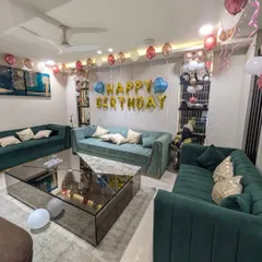 A wider view of the living room decoration, showing how the balloons fill the space and create a celebratory atmosphere.