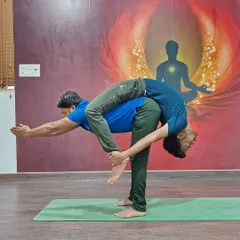 This impressive partner pose combines a standing forward bend with a backbend, requiring immense trust and mutual support.
