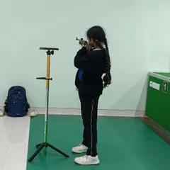 A young student from our Greenwoods High International School program practices her standing position. We work with schools to introduce shooting as a sport that builds focus and character.