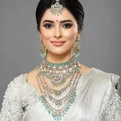 A direct, smiling portrait from the same high-fashion shoot, showcasing a look that is both glamorous and approachable.