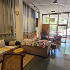 The living area in my home is versatile, with furniture that can be easily rearranged. The back of the sofa doubles as a low seating area, demonstrating how every element can serve multiple functions in a compact space.