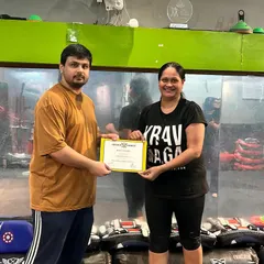 Recognizing a student's achievement. Her hard work and commitment to training have paid off.
