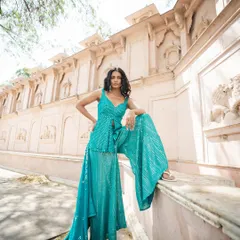 This is for anyone who feels the pressure to buy a new outfit for every wedding. This teal mirror work sharara set is fun, stylish, and comfortable. Rent it, wear it, return it, and forget about the dry cleaning bills and closet space. We get it.
