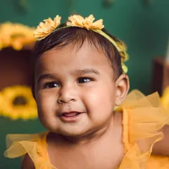 Our little sunflower. A close-up shot capturing a beautiful, happy expression during our popular sunflower-themed session.
