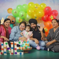 The whole family is here to celebrate! Grandparents, parents, and aunts all joined in for this happy Cocomelon-themed family photo.