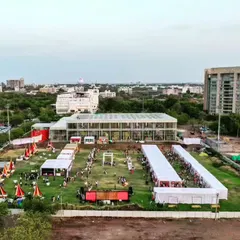 A ground-level view of our Glass Pavilion project, a versatile space for events and gatherings. The transparent design seamlessly blends the interior with the surrounding landscape.