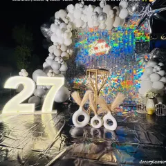 For a 27th birthday that needed to be extra glamorous, we designed this stunning silver sequin backdrop. The glowing marquee numbers and modern pampas grass decor created a chic, photo-perfect spot for a night of celebration.