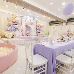 The full party space for Radha's birthday, showing the grand castle stage, the elegant dining area, and a perfectly coordinated pink ball pit for the little ones.