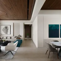 The living and dining areas of Lumen House are unified by a 12-foot ceiling and warm wood paneling, creating an expansive feel. We used pops of teal in the ottoman and artwork to add a cool contrast to the neutral, light-filled space.
