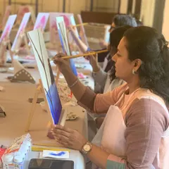 A participant at our corporate workshop in Kochi, focused on her painting. It's a great way for teams to unwind and connect outside of the usual office environment.