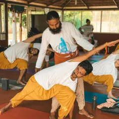 I believe in guiding each student personally. Here, I am offering a gentle adjustment in a forward fold, helping the student to find space and release tension safely. My approach is to meet you where you are, with patience and support, so you can trust your body and deepen your practice without force.