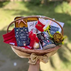 We love creating gifts that celebrate multiple special moments at once. This custom wicker basket was designed as a combined Christmas and Birthday hamper, featuring festive holiday items alongside a personal birthday card and treats.