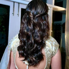 A detailed look at the soft, twisted half up-do hairstyle that perfectly completes this classic bridesmaid look.