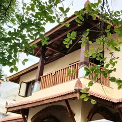 This west-facing balcony is shaded by a deep wooden truss canopy. It softens the harsh afternoon sun, keeping the inner rooms cool while providing a cozy, elevated space to interact with the surroundings.