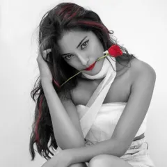 An artistic portrait using a selective color technique. By keeping the image monochrome except for the red rose, lips, and hair, I created a dramatic and intense look that is both modern and timeless.