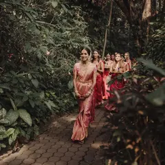 The arrival of the bride is always the most poetic moment. Here, Vidya and her girls walk amidst the rustling leaves and dancing sunlight at the Taj Westend, a bridal entry that perfectly captures the anticipation and joy we love to orchestrate.