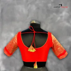 This deep red brocade blouse is a statement of elegance. The rich texture of the fabric and the classic U-back with a dori tie make it a sophisticated choice for any wedding or festive event.
