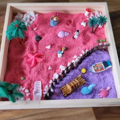 A finished Zen garden from one of my workshops. This creation features a beach scene with pink and purple sand, showing how each child brings their unique imagination to this meditative art form.