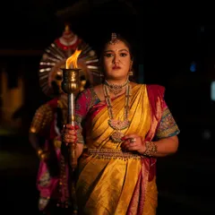 A powerful photo from the 'BELAKU' concept, where Meghana Raj holds a torch, symbolizing the victory of light over darkness, a core theme of Navratri.
