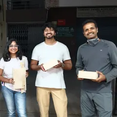 Proudly showing off their handmade projects. This group created a serving board and a pair of sturdy wooden boxes, learning essential skills along the way.