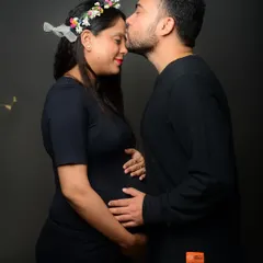 A tender kiss on the forehead. This intimate gesture beautifully captures the love and excitement of the parents-to-be during their maternity shoot.