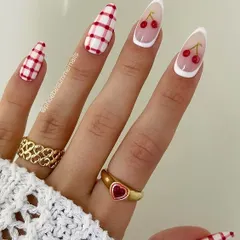 A classic red and white version of the cherry and plaid nail art trend. The white French tip makes the cherry art pop.