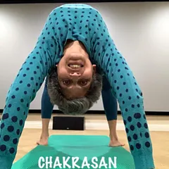 A playful variation of Chakrasana, looking through my legs. Yoga should be joyful and explorative.