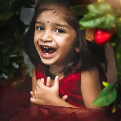 The pure, unscripted joy of a happy child. This candid shot of a toddler's laughter is a great example of the spontaneous moments I capture.