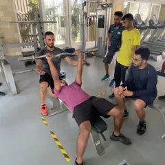 Correcting form on the bench press during a CSCS practical session. My mentorship focuses on providing immediate, specific feedback to help coaches master the fundamental lifts and effectively teach them to their own athletes.