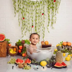 Our milk bath sessions are pure joy. We fill a tiny tub with a safe, warm bath and lots of colorful fruits, creating a playful sensory experience that brings out the biggest smiles.