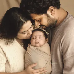 A beautiful, tender moment between parents and their newborn daughter. These are the quiet, love-filled portraits that become family heirlooms.