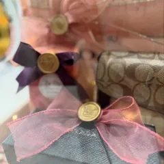 The beauty is in the details. This close-up shows the delicate organza ribbons and custom wax seals on individual gifts within the trousseau box.