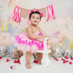 A first birthday shoot is a perfect way to celebrate. This little princess is enjoying her session on a cute tricycle, one of the many props I offer.