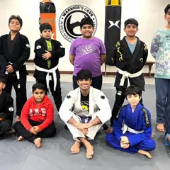 Our Little Warriors BJJ team poses for a group photo. The bonds formed on these mats extend beyond the gym, building friendships based on shared effort and respect.