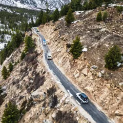 Following a convoy of vehicles as they navigate the challenging, winding roads of Spiti. This aerial shot tells a story of adventure and exploration in the remote Himalayas.