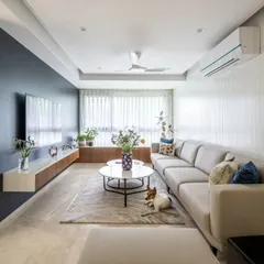Even a compact apartment can feel spacious and luxurious. For this 950 sqft home, we used a light color palette, smart storage, and a long sectional sofa to create an open, inviting living area that even the family pet loves.