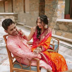 A playful moment between the couple during their Haldi ceremony, full of laughter and genuine affection.