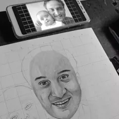 This image shows my process: the reference photo is on my phone, and the gridded sketch is underway on the paper below. It's how I ensure accuracy in my family portraits.