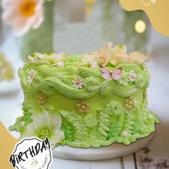 A little garden bloomed on this cake for Ritika's birthday in Vasant Vihar. The light green buttercream is decorated with intricate piping of ferns, flowers, and a delicate pink butterfly.