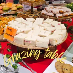 A beautiful grazing table setup for a watch launch party at a shopping mall. This spread includes mini sandwiches, cookies, and other finger foods, perfect for guests to mingle and snack.