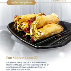 A fusion of Indian flavor in an Italian classic. Our Paan Mousse Cannoli features a crispy shell filled with aromatic paan mousse, finished with delicate rose petals and pistachios for a truly unique dessert.