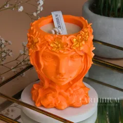 This vibrant orange Jesmonite candle holder, shaped like a beautiful woman with a floral crown, adds a soulful and artistic touch to your space.