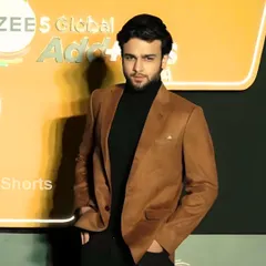 Actor Kaul Me graces an event styled in one of my creations. He wears a sharp brown suede blazer over a black turtleneck, a look that steals the spotlight with its understated luxury.