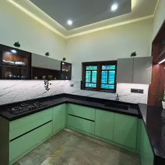 This kitchen concept uses a refreshing pastel green acrylic finish for the base cabinets, contrasted with grey upper cabinets and a 3D-patterned backsplash. The result is a bright and modern cooking space.