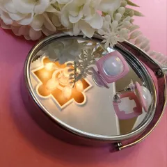 Another creative shot of the pink enamel square earrings, showing their reflection and unique design.