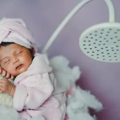 A fun and unique 'spa day' theme for a newborn. The tiny bathrobe, towel wrap, and shower prop make for a super cute and memorable photo.